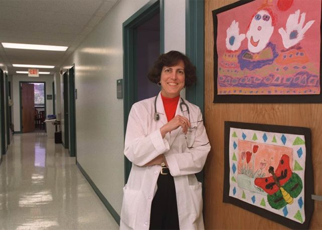 Dr. Botash in front of door with kids drawings