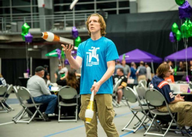 A teenager juggling at event